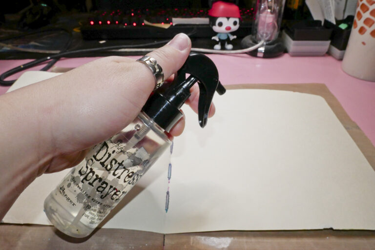 Spraying Art Journal with Water