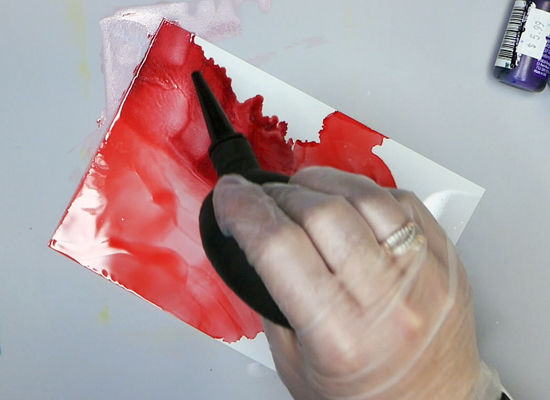 Using a dust blower to create an alcohol ink background