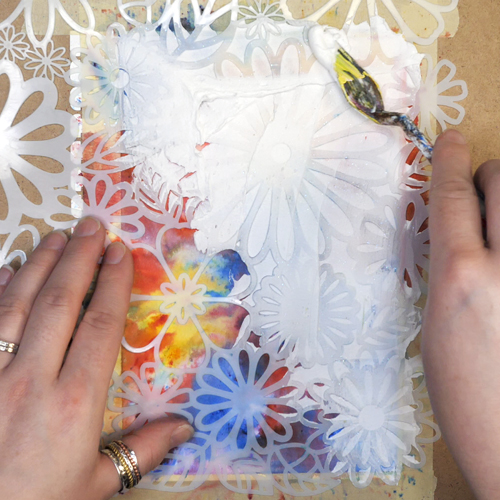 Adding Aleene’s Glitter Snow through TCW Stencil Flower Frenzy with a palette knife