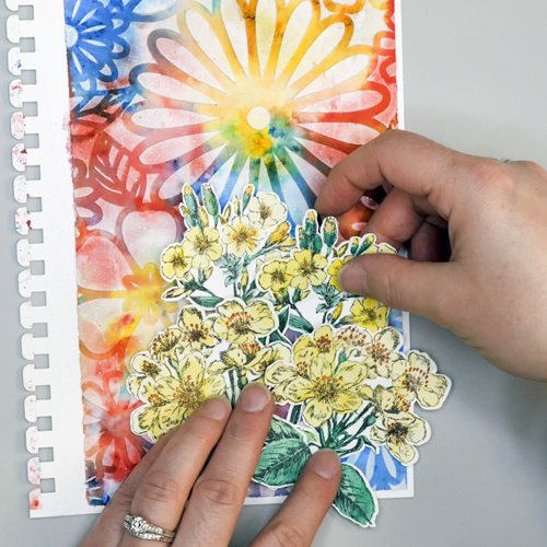 Assembling Art Journal Page by attaching Stamped and Painted images with Thermoweb Zots
