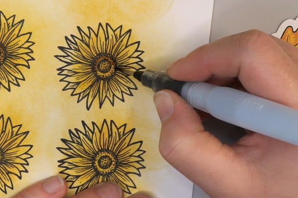 Using a Water brush to add Tim Holtz Distress Ink Walnut Stain to Sunflower