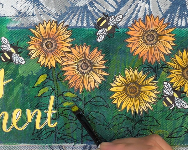 Adding highlights and shadows with acrylic paint to leaves and stems of sunflowers