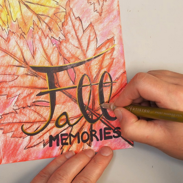 Adding Artistro Gold Paint Pen to Lettering on Art Journal Page with Leaf Rubbings