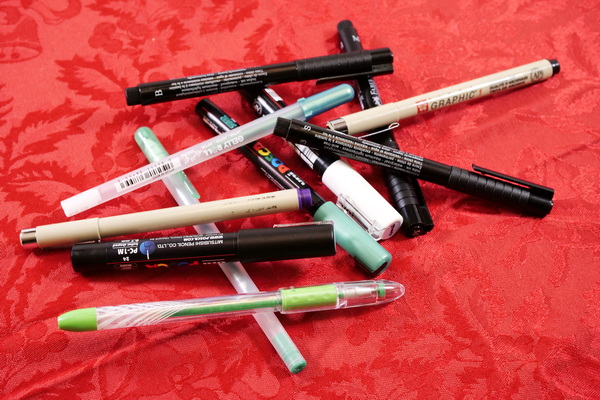 Best pens for mixed media including Posca paint pens, Faber Castell Pitt Pens, Sakura Gelly Roll pens, Sakura Micron Pens