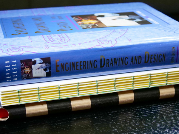 Makeshift book press for book binding using heavy textbooks