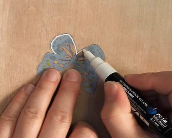 Adding Posca White Acrylic Paint Pen to Tim Holtz Ideaology Transparent Wings