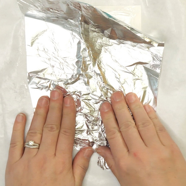 Crinkling aluminum foil on paper to create texture for cards