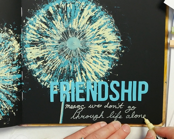 Adding journaling with a Tooli Art Pastel Paint Pen to an art journal page about friendship