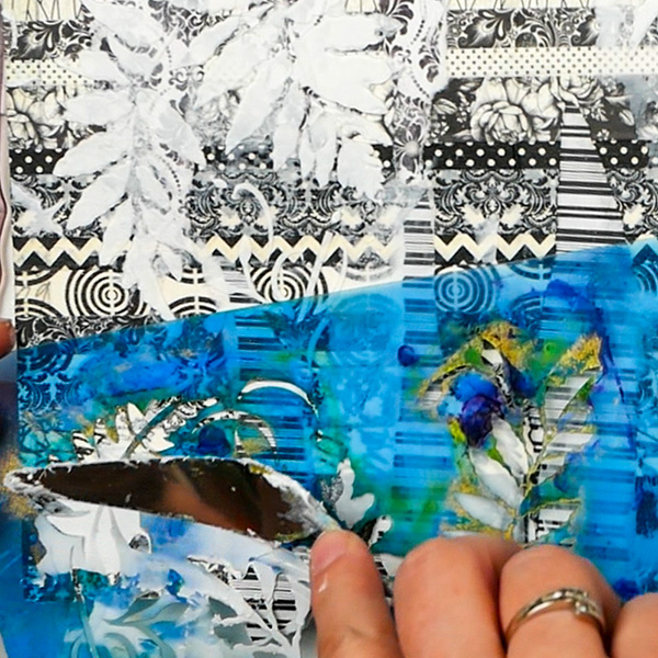 Adding Liquitex Flexible Modeling Paste through a stencil on collage art journal page