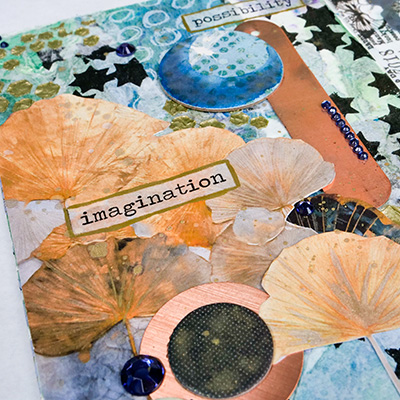 tissue paper collage with chipboard and gems