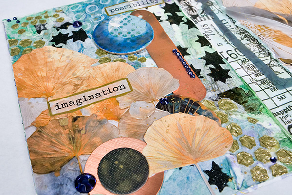 tissue paper collage with chipboard and gems