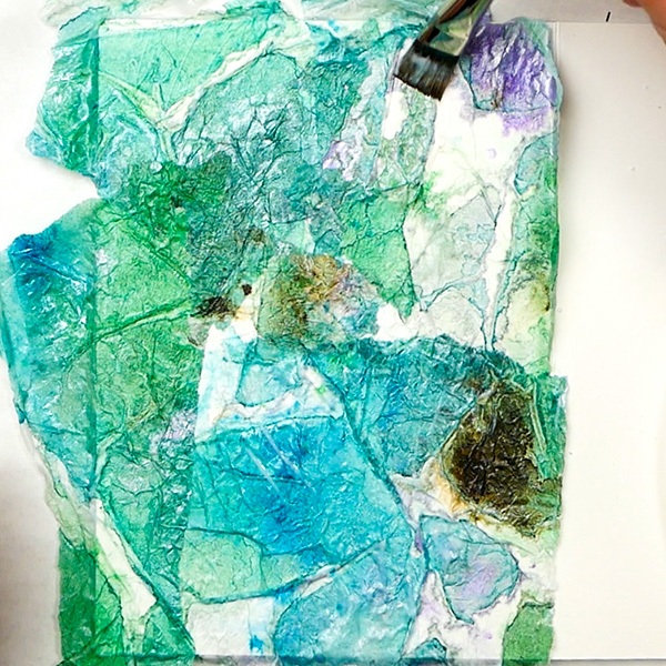 Adding tinted tissue paper to art journal page