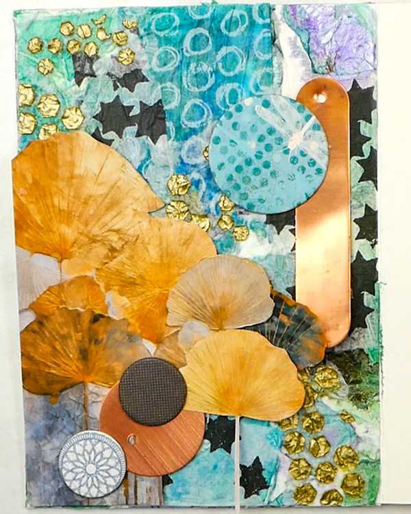 Adding chipboard and copper pieces to tissue paper collage