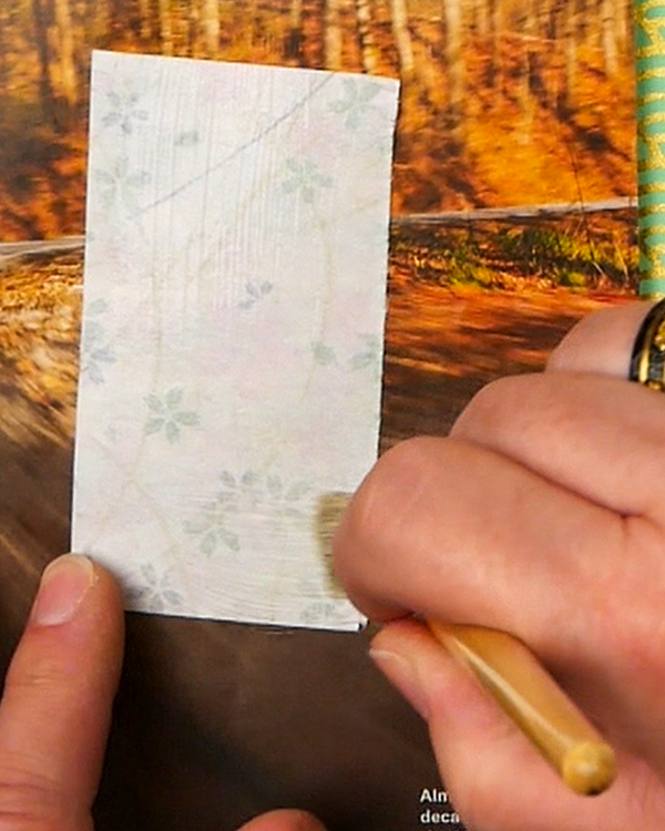 Brushing on glue using my secret glue recipe for collage