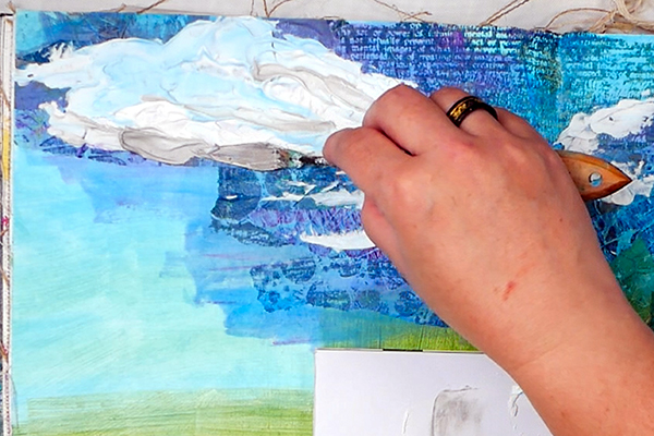 Palette knife painting clouds with shadows onto textured collage