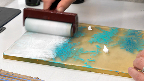 Adding a layer of paint to a gel plate leaf print