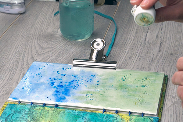 Adding brusho crystal colors to art journal page
