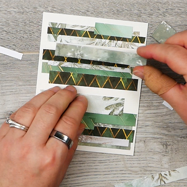 Adding layers to abstract holiday card made from paper scraps