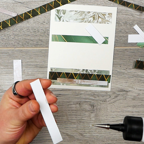 Adding layers to abstract holiday card made from paper scraps