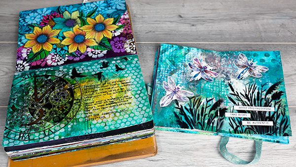 Double page and single page spreads in an art journal. Artwork by Nadine Milton