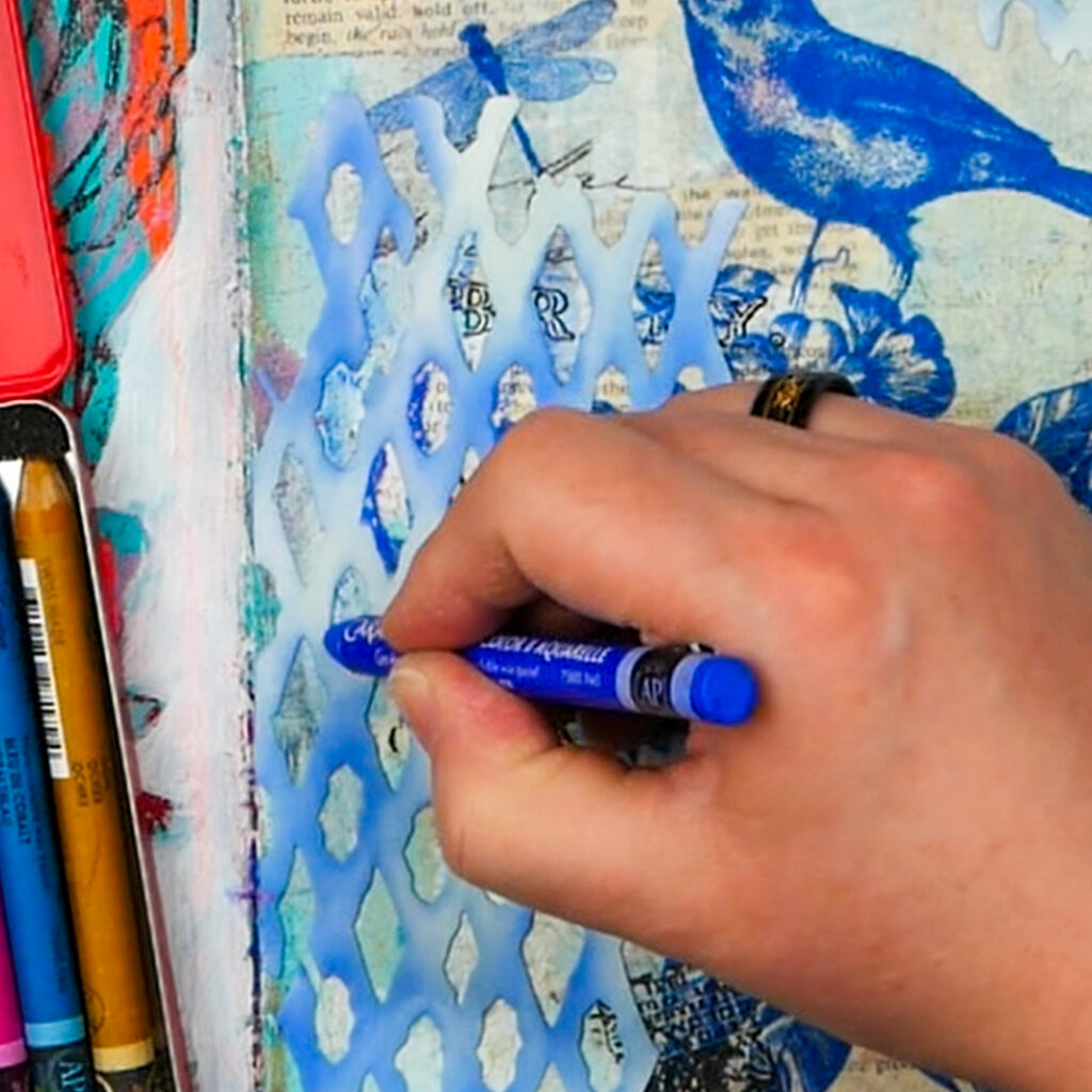 Adding in Caran d'Ache Aquarelle Watercolor Crayons to add highlights to mixed media art journal page
