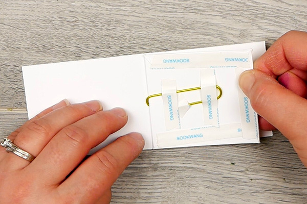 Lining up paper for back and front of paperclip art cover