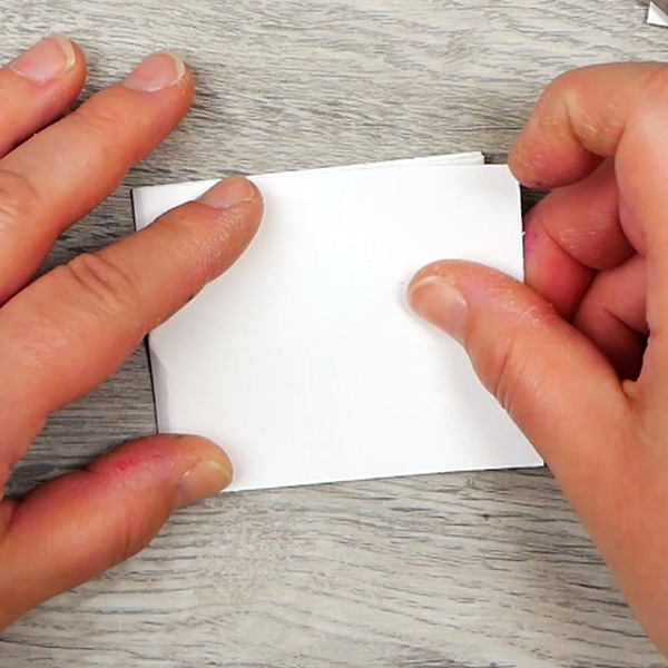 Folding paper to create cover for a paperclip