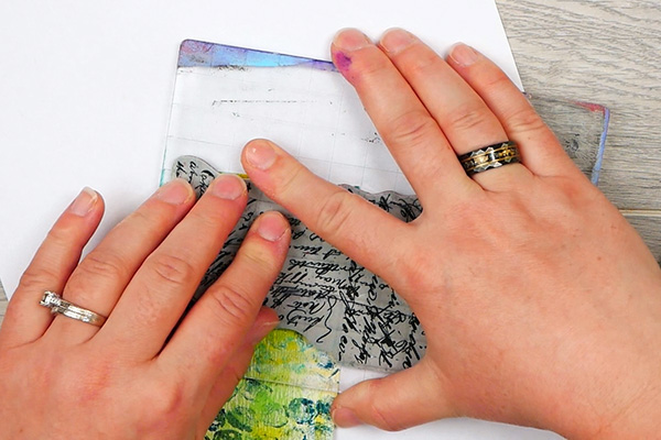 Stamping Tim Holtz Ideaology Script Stamp on decorative paperclip bookmark