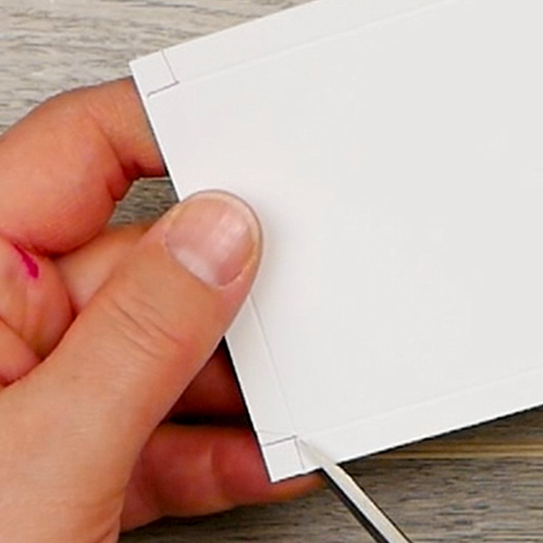 Mitering the corners to fold the inside cover of an art paperclip