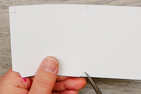 Mitering the corners to fold the inside cover of an art paperclip