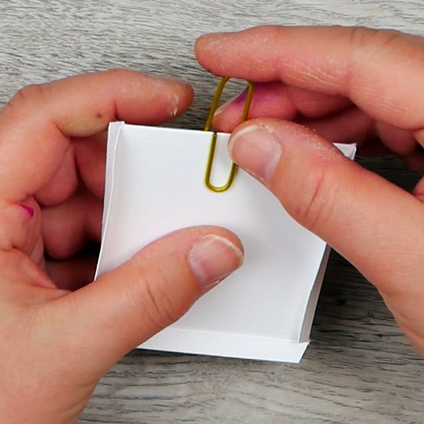 Adding paperclip to folded paper to create the backside of the paperclip art