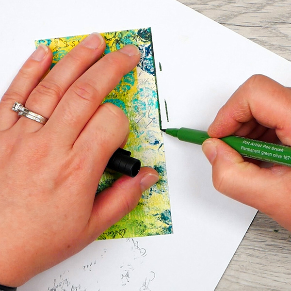 Adding green Pitt pen to edge paperclip bookmark cover